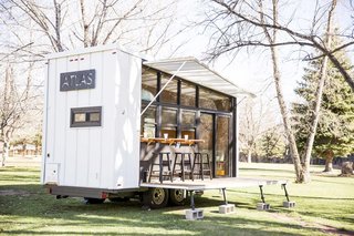 10 Tiny Trailers to Take on an Adventure - Photo 2 of 10 - Unpacking the deck and awning reveals a glass wall that opens the trailer to its environment, wherever that may be. ATLAS can be hitched to a truck to travel easily from campsite to campsite.