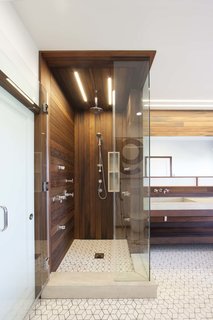 10 Best Modern Showers to Inspire Your Bathroom Renovation - Photo 10 of 10 - When Chris Brigham, founder of Knife & Saw, discovered water damage in the master bathroom of his San Francisco home, it turned out to be a blessing in disguise. The furniture maker and his wife had never loved the space, and Brigham took the opportunity to renovate with the help of designer/builder Fidel Archuleta of ArcSon Design. Lighting in the bathroom is provided by San Francisco-based Aion LED’s modular fixture system. The linear lighting mimics the redwood siding.