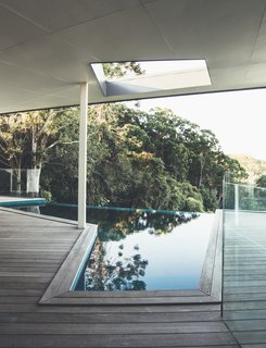 The geometric pool also captures views of the lush landscape.