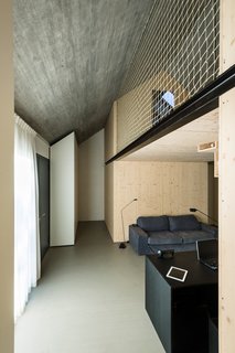 The interior dry walls are made of layered spruce plywood panels, rubbed with transparent oil. The ceiling is concrete.