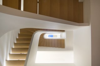 11 Modern Stairways That Do Way More Than Just Connect Floors - Photo 4 of 11 - Space4Architects created a serene and fluid space on the Upper West Side. Shown here is the Piranesian view that looks upwards through the central stair to the top floor skylight.