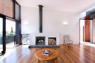 An Australian Beach Home with Stunning Ocean Views - Photo 6 of 8 - Immediately to the right of the entry is the main living space, which features a Jetmaster 700D wood-burning fireplace.