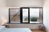 External shutters and screens allow the homeowners to manage the sunlight and cross ventilation in certain rooms. Manos Mavridis, also of OLA Studio, explains, “There was a preference for the screens to be manually operated to minimize ongoing maintenance costs and encourage user engagement with their environment." Photo 6 of Martha modern home