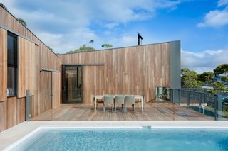An Australian Beach Home with Stunning Ocean Views - Photo 2 of 8 - To reduce the home's environmental footprint, OLA installed rain water collection tanks and solar panels, which the house relies upon for water and electricity. White tile and tan travertine pool pavers mimic the color palette of the nearby beach.