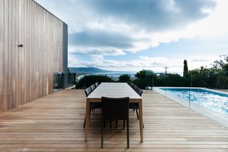An Australian Beach Home with Stunning Ocean Views - Photo 3 of 8 - A Mood Outdoor Table by Studio Segers for Tribù is surrounded by Terra Outdoor Chairs by Bram Bollen, also for Tribù. They rest atop silvertop ash hardwood decking.