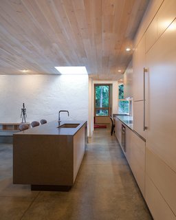 "One large room is overrated, and a bedroom opening off a great room doesn’t work well if someone sleeps in or goes to bed early," Jones says. "So there are halls, which I think need to make a comeback." Quartz countertops and Douglas fir cabinets surround the kitchen sink and faucet by BLANCO Canada.
