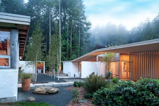 "The new house is not shy to look across at the old house, where you can see old rough stucco on one building, and then the same stucco on our new building," Jones says.
