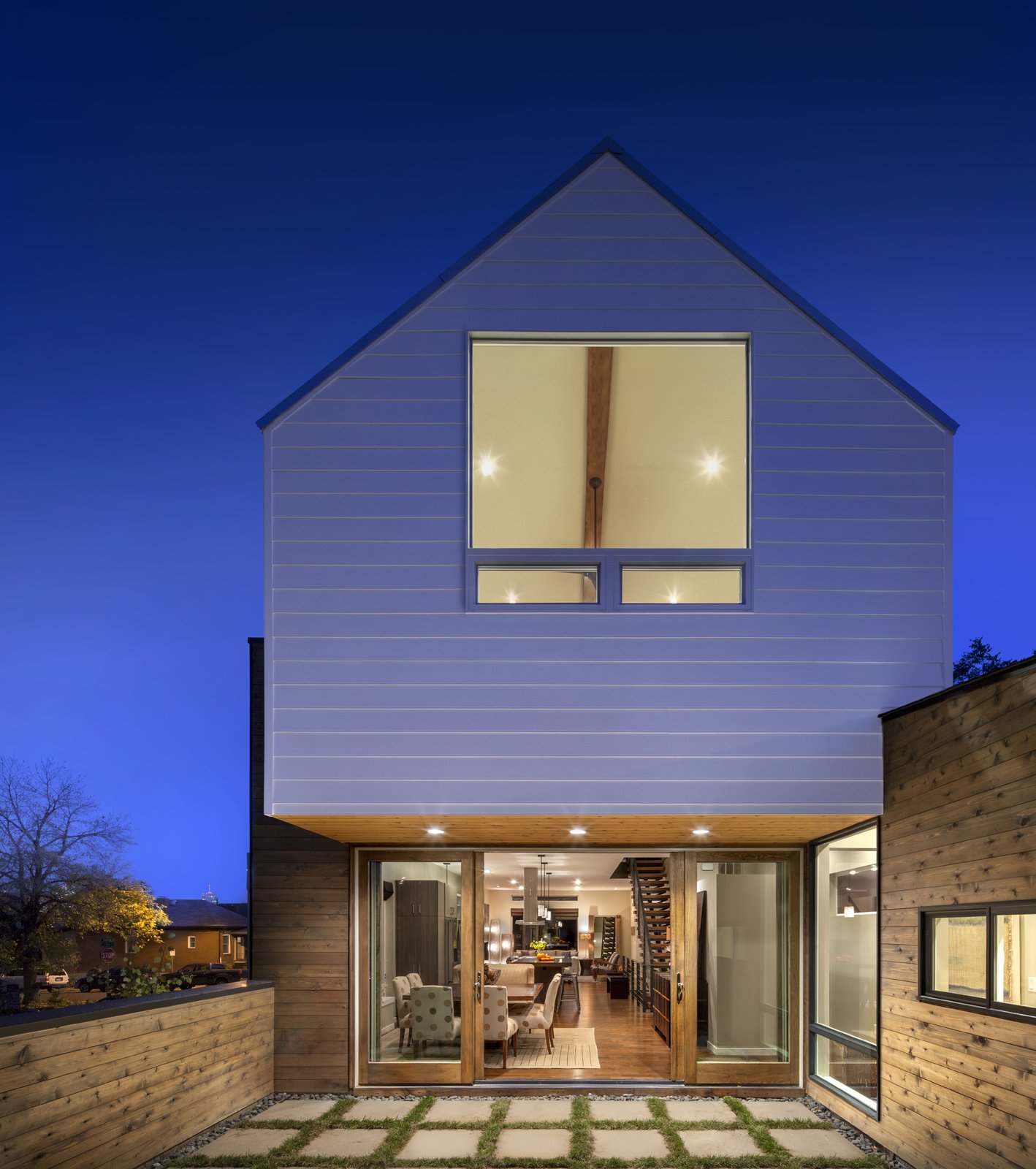 “We were concerned that by elevating the first floor by six feet, we would be detaching the living space from the neighborhood,” Mitchell says. “Thus, we have an elevated exterior patio off of the rear that overlooks the sidewalk and brings the living space to the outdoors.”