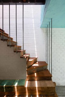 10 Dazzling Modern Staircases - Photo 2 of 10 - Reclaimed wood, weathered steel risers, wood treads, and steel rebar supports work together to create this unique staircase designed by Saigon-based architect Toan Nghiem of a21 Studio. Despite the stair's modern silhouette and use of steel, the materials collectively create a warm, inviting palette.