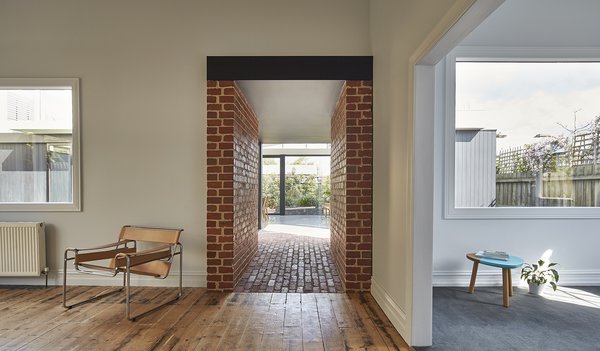 “Instead of extending the new living area from the existing house, we decided to build a stand-alone structure off the front house and connect the two spaces with a central passageway,” Ong says. This made the back of the home distinctive from the Edwardian front. Recyled brick was used to create the connecting hallway. Photo 8 of Breeze modern home