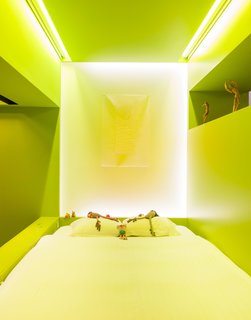 A Creative Dreamworld Complete With Neon Rooms and a Tropical Garden - Photo 1 of 11 - Husband and wife Tim Stokes and Nathalie Wolberg left their pint-size Parisian apartment behind to undertake a hands-on renovation of an industrial, 6,000-square-foot warehouse in Antwerp, Belgium. It’s now home to an expansive live/work space containing two studios—one for each of them—two exhibition galleries, and an integrated courtyard.