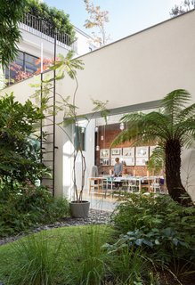 A Creative Dreamworld Complete With Neon Rooms and a Tropical Garden - Photo 5 of 11 - She also designed the table, surrounded by vintage Wishbone chairs by Hans Wegner, in her studio.