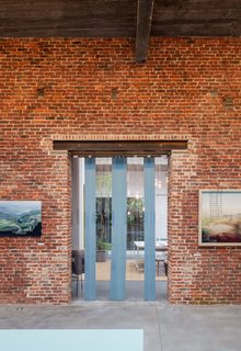A Creative Dreamworld Complete With Neon Rooms and a Tropical Garden - Photo 9 of 11 - With 5,000 square feet on the ground floor, the structure boasts two capacious exhibition spaces, which the couple use to show their own work, as well as rent out to others for private events.