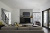 “We had to take into consideration that this young family was going to be living on a viable farm,” says interior designer Kris Ozburn of Second Mile Design. “So, selecting furniture that was practical but had good design was a priority.” Ozburn chose pieces like the sectional sofa from Precedent that felt timeless and modern. Photo 5 of The Farmhouse modern home
