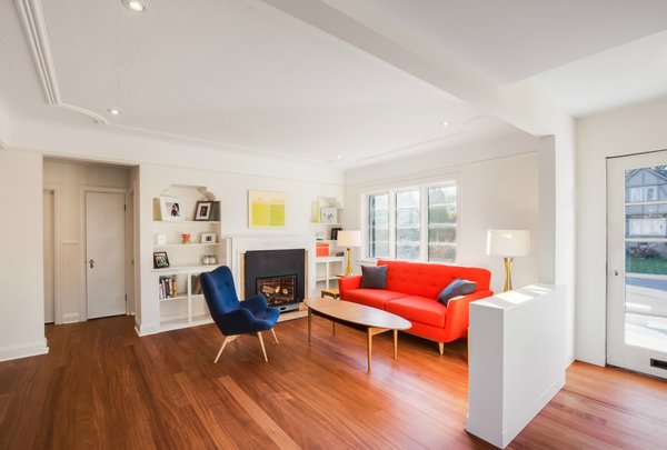 Although the main goal for the renovation of the ground floor was to create a more open floor plan, it was equally important to preserve as many details as possible. The plasterwork on the ceiling and the marble fireplace are both original features. A Florence sofa from Van Gogh Designs stands across from a feather lounge chair by Elite Living. Photo 2 of Art Moderne modern home