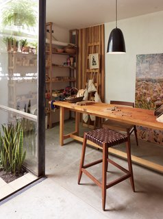 One-of-a-Kind Furniture Fills This Delightfully Serene Buenos Aires Home - Photo 9 of 10 - In her workshop, which features a Mercedes table, an Otto lamp, and a wood-and-leather bar stool, all by NET, she creates a line of uncomplicated wood toys called Sarmiento.
