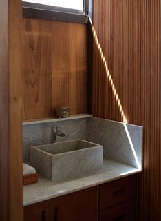 One-of-a-Kind Furniture Fills This Delightfully Serene Buenos Aires Home - Photo 8 of 10 - A Carrara marble sink in the bathroom is surrounded by Brazilian pine and cypress.