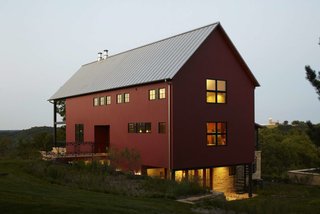 These 10 Refreshed Barns Bring Modern Living to the Countryside - Photo 3 of 10 - From red painted cedar siding to no-fuss structural elements, Northworks’ solution reaches a happy medium between the classic barn look and a weekend retreat.