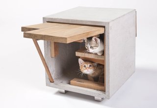 The Cat Cube by Standard Architecture | Design of Los Angeles has two openings and is made with reclaimed wood and concrete. The concrete heats up during the day to provide strays with a source of warmth at night.