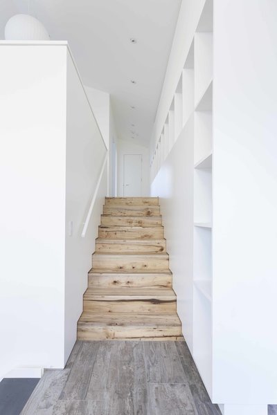 Executing subtle design details, even in transitional spaces, was one of the great successes of the collaborative architect-contractor relationship. "Our collective strength," says Dovetail principal Chad Rollins, is that “we genuinely understand each other’s craft.” In the transition from the den to the artist studio, natural myrtlewood stairs meet a wood-grain Daltile landing. Where the stair treads and risers meet the wall, a three-quarter-inch reveal is placed in lieu of conventional baseboard. These simple and clean details so often “can be costly to create and can be jeopardized when the budget is under pressure,” says Rollins. Photo 6 of Central District Residence modern home