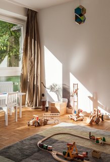 We Can't Get Enough of This German Apartment's Sleek Matte-Black Kitchen - Photo 10 of 11 - A Colour Carpet by Scholten & Baijings for HAY defines the play area in Morten’s bedroom.