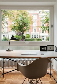 We Can't Get Enough of This German Apartment's Sleek Matte-Black Kitchen - Photo 11 of 11 - A small office for Dorothee, furnished with a desk by German architect Egon Eiermann and an Eames chair, overlooks the street.