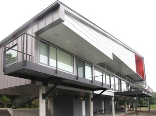 A Couple Builds Their Dream Retreat in the Hudson Valley - Photo 1 of 8 - "A majority of the house is lifted on concrete columns to maximize the views and also provide a covered ground plane for protected parking and outdoor living," Mulvena says. "Future additions to the house can be built on this ground level within the existing structure."