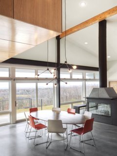 A Couple Builds Their Dream Retreat in the Hudson Valley - Photo 6 of 8 - "The windows and patio doors, all made from super low-E insulated glass, open onto the amazing views and give easy access to expansive decks and a pool terrace," Mulvena says. His team conducted solar studies and installed a retractable screen from MechoShade that would shade the house in the summer.