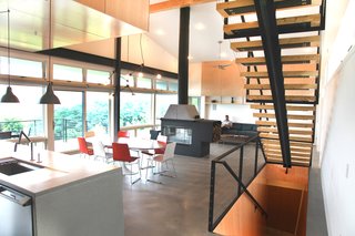 A Couple Builds Their Dream Retreat in the Hudson Valley - Photo 4 of 8 - The couple plan to retire in this home; its capacious interior is designed to host multiple generations of family. IKEA lights stands over a Kohler faucet in the kitchen.