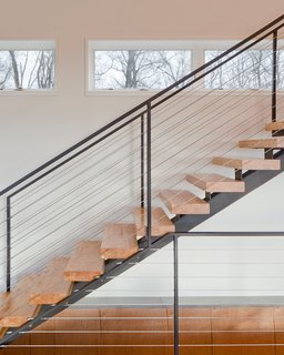 A Couple Builds Their Dream Retreat in the Hudson Valley - Photo 5 of 8 - "The clients desired a maintenance-free, year-round home using the ultimate in ‘green’ building methodologies," Mulvena says. The staircase is an example of the construction’s mindset: it is made from the leftover laminated veneer lumber used on the roof.