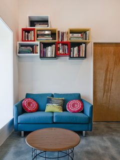A Couple Builds Their Dream Retreat in the Hudson Valley - Photo 7 of 8 - However, relying solely on concrete was not the best use of the budget, so Mulvena "balanced the concrete floors and highlights with a simple palette of affordable but industrial materials: black steel and plywood." The couch is by BoConcept.