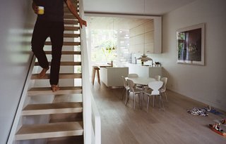 In undertaking a gut renovation of a town house in Brooklyn’s Park Slope neighborhood, husband and wife Jesper Meyer and Rimjhim Dey drew upon design elements from their respective roots in Denmark and India to create a home that’s wholly serene and accented with subtle pops of bright color. American white-oak planks, finished with lye and pigmented with whitening oil from Danish company Junckers, line the staircase and floors throughout; the dining area is furnished with Ant chairs by Arne Jacobsen and a PH50 pendant by Poul Henningsen for Louis Poulsen.