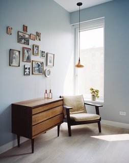 A touch of nostalgia marks the upstairs home office, furnished with several vintage pieces: a teak Danish dresser, a Hans Wegner armchair, and Jo Hammerborg’s 1962 Orient pendant, made from a copper shade with rosewood detailing.