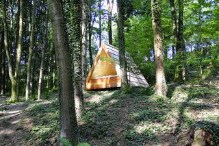 10 Tiny Homes You Can Build - Photo 8 of 10 - The Villa Massive, produced by the Slovenian company Lushna, is a rugged sleeping unit that sports a large triangular window and larch shingles. It also comes with a ventilation system and exterior LED lighting.