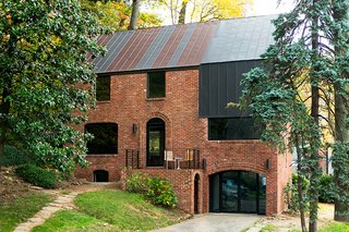 Steel Preserve - Photo 1 of 5 - In Arlington, Virginia, a drafty house was made more than twice as efficient with the addition of metal both inside and out. Roof panels topping the brick envelope echo its original geometry. 