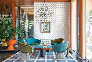 Jonathan Adler and Simon Doonan Go Trippy Contemporary on Shelter Island - Photo 3 of 12 - "There's no right answer except to play and experiment," Adler says about furnishing the interior. He reupholstered vintage Warren Platner chairs with velvet from Kravet. Drawings by Eva Hesse inspired the custom ceramic wall tile. Adler also created the coffee table, rug, planters, and gold stool. The pendant lamp is from Rewire in Los Angeles and the artwork is by Jean-Pierre Clement.