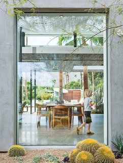 One Canadian Family Beats the Cold by Escaping to Palm Springs - Photo 11 of 12 - A floor-to-ceiling window frames the dining area.
