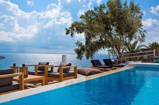 Outdoor furniture with clean lines introduce warm wood tones that fit in with the surroundings.
