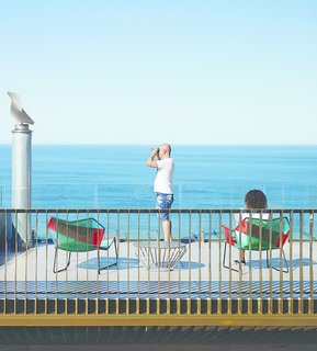 This Surfer Rules the Ocean from a Cliffside House - Photo 4 of 9 - The rooftop terrace is furnished with a Tropicalia chair and chaise longue, designed by Urquiola for Moroso, and a Jil table by Justin Hutchinson for Tait Outdoor.