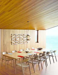 This Surfer Rules the Ocean from a Cliffside House - Photo 6 of 9 - Wardle's firm also designed the dining table, where up to ten guests can gaze out at the Southern Ocean. The solid-oak Hiroshima chairs are designed by Maruni.