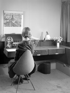 Arne Jacobsen designed nearly every element of the hotel, including the built-ins, textiles, and accessories. In addition to furnishing the rooms with existing pieces from his portfolio, Jacobsen created new pieces for the hotel, like the Drop chair shown in this archival photo.