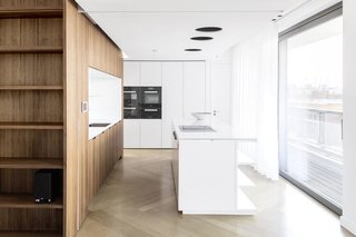 The kitchen, with a custom island by the architects, has a Blanco sink and Dornbracht fixtures. 