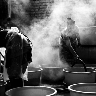 From Denmark to Nepal—Masters of Their Crafts Unite - Photo 2 of 8 - Being the first development project that Menu has taken on, they worked intently for three years to build a system that would truly be beneficial for the Nepali women. Taken in Nepal's capital Kathmandu, women are shown here dyeing wool with a technique developed by the local community. Next, the wool will be woven into throws and blankets.