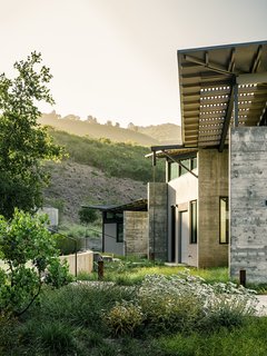 Retirement Never Looked Better and More Sustainable - Photo 4 of 10 - Trainor planted native grasses and yarrow as a visual buffer between the house and the natural site. Feldman chose Douglas fir beams as the board forms for the site-poured concrete walls. "The rough texture of the concrete helps tie the house to this dynamic and wild setting," he says.