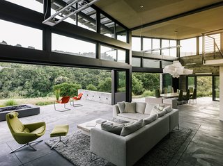 Retirement Never Looked Better and More Sustainable - Photo 6 of 10 - In the open living-dining area, a sofa by Antonio Citterio joins a Metropolitan chair and ottoman, all from B&B Italia. A Big Bang fixture from Foscarini hangs above the dining room table, designed by Feldman and surrounded by chairs from Ligne Roset.