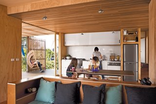 Students Pass Their Class by Building a House in New Zealand - Photo 4 of 7 - A dishwasher by Miele, refrigerator by Mitsubishi, and Baumatic cooktop are nestled into the custom kitchen, which features laminate-covered cabinets and a stainless steel countertop.