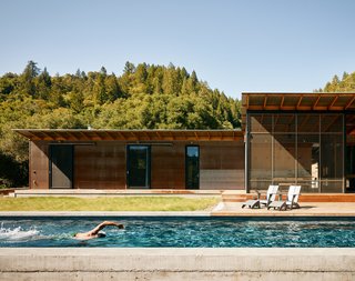 A modern interpretation of the traditional dogtrot home, Camp Baird comprises two cabins placed along an L-shaped orientation. An elongated, solar-heated lap pool runs the length of the south-facing side, alongside an expansive ipe deck that measures nearly 1,600 squarefeet. The lounge chairs are by Loll Designs. 
