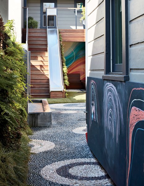 In the Mission District yard Monica Viarengo created for the Sharkey family, outdoor chalkboard paint by Sydney Harbour applied to marine-grade plywood offers a gallery for creativity. A mural by local artist Erik Otto—inspired by the neighborhood—brightens the back of the space.