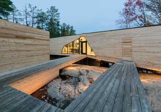 The three-bedroom home is connected to a dock house, garage, and vegetable garden by a network of wood walkways and decks.