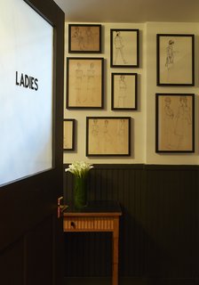 This Boutique Hotel Loves its City Like No Other - Photo 7 of 14 - Illustrations discovered at Paris's Les Puces flea market adorn a bathroom wall. 